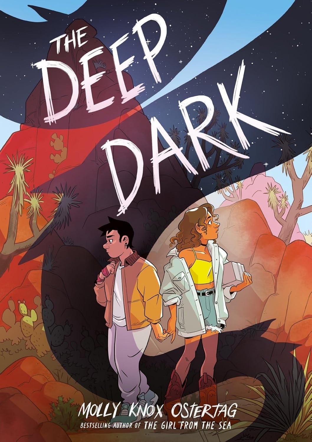 Cover for the YA graphic novel The Deep Dark by Molly Knox Ostertag. Depicted are two teenage girls facing away from each other, their hands barely touching, in a rocky desert background. The daylight scene is streaked through with shadows of a night sky.